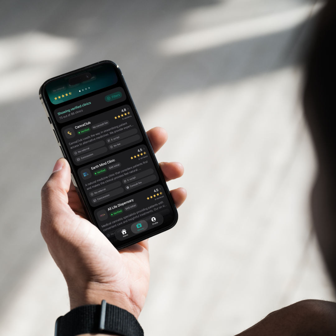 Person holding a phone showing verified clinics in the Cannect app.